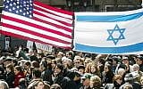 Demonstrators walking beneath Israeli and American flags at a pro-Israel rally at Dag Hammarskjold Plaza in New York City, April 7, 2002. (Mario Tama/Getty Images)