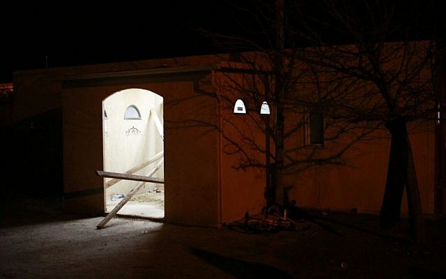 Settlers barricaded the entrance to Amona synagogue on February 1, 2017, in an effort to delay the evacuation of the site as the West Bank outpost was cleared by security forces. (Judah Ari Gross/Times of Israel)