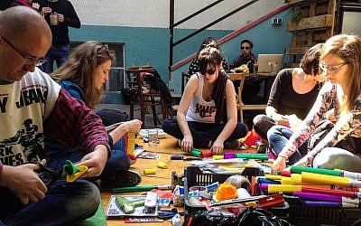 Activists preparing an educational activity at the Aurora center, April 23, 2016. (Courtesy of Aurora via JTA)