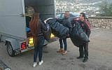 Israeli volunteers packing winter supplies to be delivered to Syrian refugees. (Operation Human Warmth)