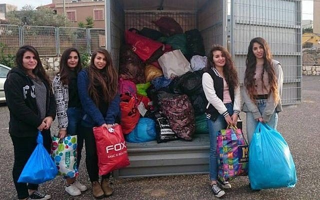 Israeli volunteers packing winter supplies to be delivered to Syrian Refugees. (Operation Human Warmth)