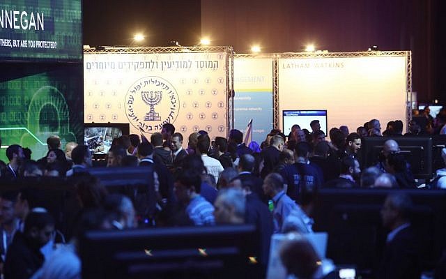 The Mossad symbol appears in the background of this picture of participants at CyberTech 2017 (Courtesy: Gilad Kavalerchik)