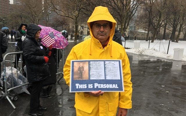 Harold Levine brought a poster to the New York City rally showing his grandfather, who immigrated to the United States over 100 years ago, fleeing anti-Semitism in his native Poland. (JTA/Josefin Dolsten) 