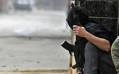 A Palestinian gunman from the Fatah movement holds his weapon during clashes between Fatah and Islamic groups in the Ein el-Hilweh refugee camp, in the southern port city of Sidon, Lebanon, Tuesday, Feb 28, 2017. (AP Photo/Mohammed Zaatari)