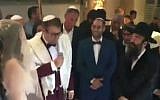 MK Oren Hazan (holding mic) gets married to Rinat Kotkovsky, February 12, 2017 (Screen capture: Channel 2)