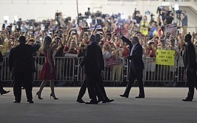 US President Donald Trump, second from right, and first lady Melania Trump, third from left, wave to the crowd following the "Make America Great Again Rally" at Orlando-Melbourne International Airport in Melbourne, Fla., Saturday, Feb. 18, 2017. (Susan Walsh/AP)