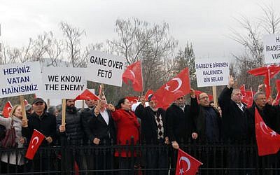 A crowd reacts as paramilitary police escort the defendants to the courthouse as a trial opened in Mugla, Turkey, Monday, Feb. 20, 2017, for 47 people accused of attempting to kill President Recep Tayyip Erdogan in a failed coup. (DHA-Depo Photos/AP)