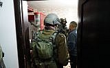 IDF troops enter the West Bank home of a Palestinian man on February 10, 2017, who is believed to have carried out a terror attack in the central Israeli city of Petah Tikva a day earlier. (IDF Spokesperson's Unit)
