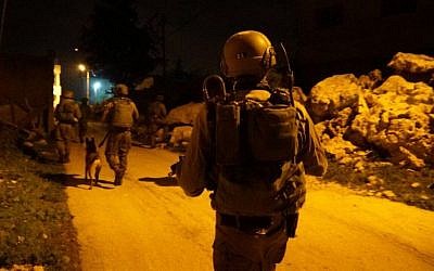 Illustrative: IDF soldiers during an arrest raid in the central West Bank on February 23, 2017. (Israel Defense Forces)