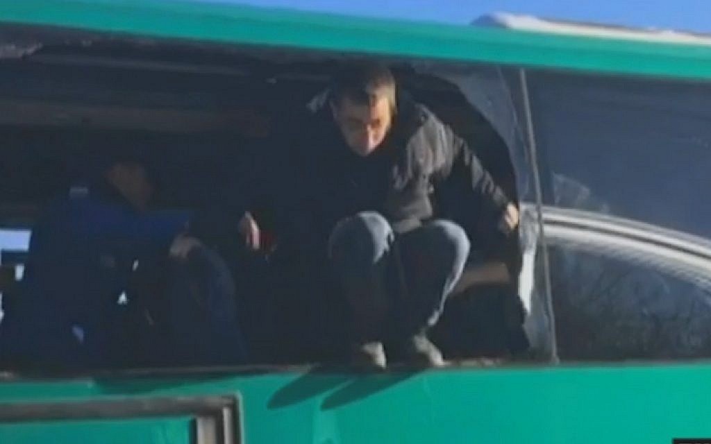 Protesters removed from the synagogue at Amona smash a window to escape after they were placed on a bus by police, during the outpost's evacuation on February 2, 2017 (screen capture: Channel 10) Protesters removed from the synagogue at Amona smash a window to escape after they were placed on a bus by police, during the outpost's evacuation on February 2, 2017 (screen capture: Channel 10)