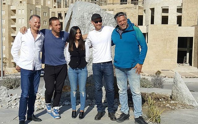 Coldplay's Chris Martin (second from left), an unidentified woman, Coldplay guitarist Jonny Buckland and producer Ilan Factor in a photograph sent out in late February (Courtesy Nidar Oz Communications) Coldplay's Chris Martin (second from left), an unidentified woman, Coldplay guitarist Jonny Buckland and producer Ilan Factor in a photograph sent out in late February (Courtesy Nidar Oz Communications)