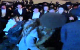Ultra-Orthodox protesters attack a woman during anti-draft demonstrations in Jerusalem on March 28, 2017. (Screen capture: Reshet TV)