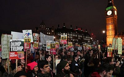 Protesters holding placards gather near the Houses of Parliament as an anti-Trump protest gets underway in London on February 20, 2017, as parliament debates whether or not to allow Donald Trump a state visit. (AFP/Justin Tallis)