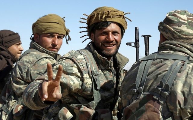 A member of the US-backed Syrian Democratic Forces (SDF) flashes the sign for victory in the village of Sabah al-Khayr on February 21, 2017. (Delil Souleiman/AFP)