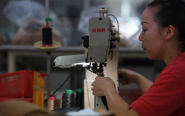 This photo taken on September 14, 2016 shows a worker at the Huajian shoe factory, where about 100,000 pairs of Ivanka Trump-branded shoes have been made over the years amongst other brands, in Dongguan in south China's Guangdong province. (AFP PHOTO / Greg Baker)