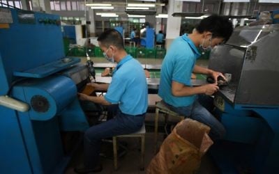 This photo taken on September 14, 2016 shows workers at the Huajian shoe factory, where about 100,000 pairs of Ivanka Trump-branded shoes have been made over the years amongst other brands, in Dongguan in south China's Guangdong province. (AFP PHOTO / Greg Baker)