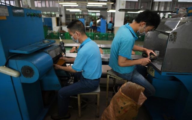 This photo taken on September 14, 2016 shows workers at the Huajian shoe factory, where about 100,000 pairs of Ivanka Trump-branded shoes have been made over the years amongst other brands, in Dongguan in south China's Guangdong province. (AFP PHOTO / Greg Baker) This photo taken on September 14, 2016 shows workers at the Huajian shoe factory, where about 100,000 pairs of Ivanka Trump-branded shoes have been made over the years amongst other brands, in Dongguan in south China's Guangdong province. (AFP PHOTO / Greg Baker)