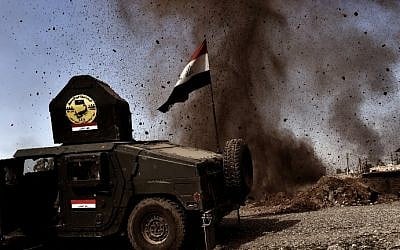 Illustrative: a mortar launched by Islamic State (IS) group fighters lands near a vehicle belonging to Iraqi forces during the assault to retake the northern city of Mosul, on February 25, 2017. (AFP Photo/Aris Messinis)