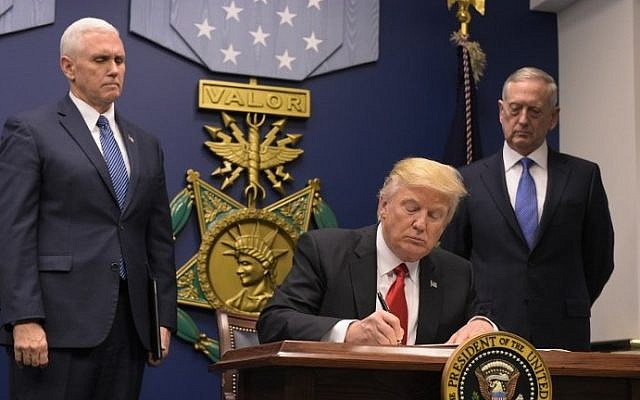 Illustrative: US President Donald Trump signing an executive order on January 27, 2017 at the Pentagon in Washington, DC. (AFP Photo/Mandel Ngan) Illustrative: US President Donald Trump signing an executive order on January 27, 2017 at the Pentagon in Washington, DC. (AFP Photo/Mandel Ngan)