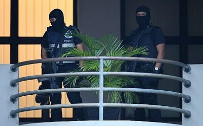 Masked Malaysian policemen keep watch ahead of the court appearance of Indonesian national Siti Aisyah, 25, and Vietnamese national Doan Thi Huong, 28, at the magistrates' court in Sepang on March 1, 2017, for their alleged role in the assassination of Kim Jong-Nam, the half-brother of North Korean leader Kim Jong-Un. (AFP/Mohd Rasfan)