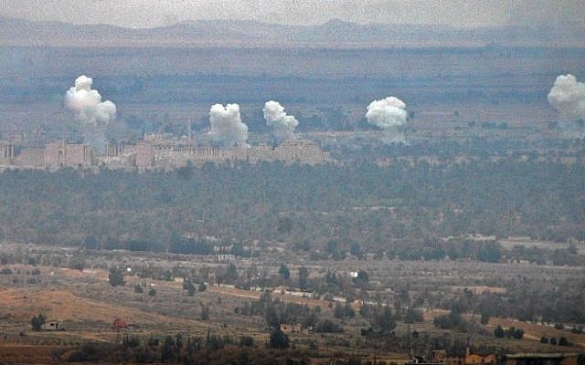 Smoke billows in the background as Syrian regime fighters advance to retake the ancient city of Palmyra, from Islamic State fighters on March 2, 2017. (AFP/ STR) Smoke billows in the background as Syrian regime fighters advance to retake the ancient city of Palmyra, from Islamic State fighters on March 2, 2017. (AFP/ STR)