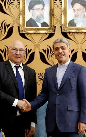 French Economy Minister Michel Sapin (L) is greeted by Iran's Minister of Economic Affairs and Finance Ali Tayebnia ahead of their meeting in Tehran on March 4, 2017. (AFP Photo/Atta Kenare)