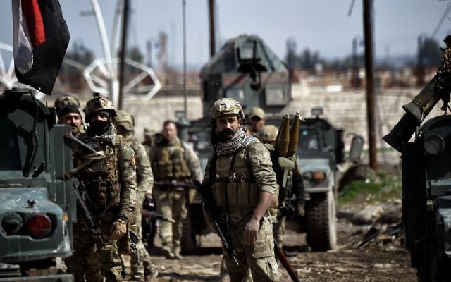 Iraqi forces gather in position as they prepare for clashes with Islamic State (IS) group fighters in Mosul on March 5, 2017, during an offensive to retake the western parts of the city from the jihadists. (AFP/Aris Messinis) Iraqi forces gather in position as they prepare for clashes with Islamic State (IS) group fighters in Mosul on March 5, 2017, during an offensive to retake the western parts of the city from the jihadists. (AFP/Aris Messinis)