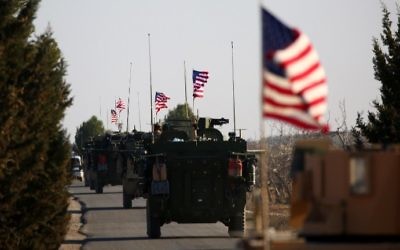 A convoy of US forces armoured vehicles drives near the village of Yalanli, on the western outskirts of the northern Syrian city of Manbij, on March 5, 2017. (AFP Photo/Delil Souleiman)