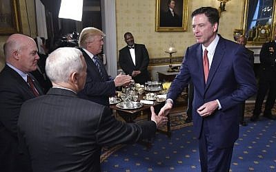 This file photo taken on January 22, 2017 shows US Vice President Mike Pence, 2nd left, shaking hands with then FBI Director James Comey, right, watched by Secret Service Director Joseph Clancy, left, and US President Donald Trump, 3rd right, during the reception for law enforcement officers and first responders in the Blue Room of the White House. (AFP/ MANDEL NGAN)