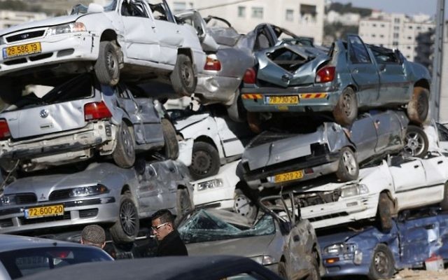 Wrecked cars with Israeli license plates are seen in the West Bank village of al-Ram on March 6, 2017. (AFP Photo/Abbas Momani) Wrecked cars with Israeli license plates are seen in the West Bank village of al-Ram on March 6, 2017. (AFP Photo/Abbas Momani)