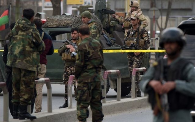 Afghan security personnel gather near the site of an explosion in Kabul on March 8, 2017. (AFP PHOTO / SHAH MARAI)
