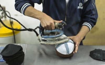 A Palestinian man works in a factory in Gaza City making kippot, or Jewish skullcaps, to be exported to Israel, on March 8, 2017. (AFP PHOTO / MAHMUD HAMS)
