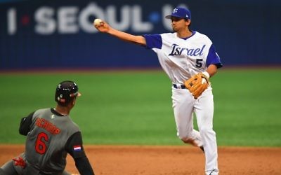 Infielder Scott Burcham (R) of Israel throws to the first base to make a double play against the Netherlands during the 8th inning of their first round game of the World Baseball Classic at Gocheok Sky Dome in Seoul on March 9, 2017. (AFP Photo/Jung Yeon-Je)