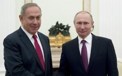 Prime Minister Benjamin Netanyahu (left) shakes hands with Russian President Vladimir Putin during their meeting in Moscow on March 9, 2017. (AFP Photo/Pool/Pavel Golovkin)