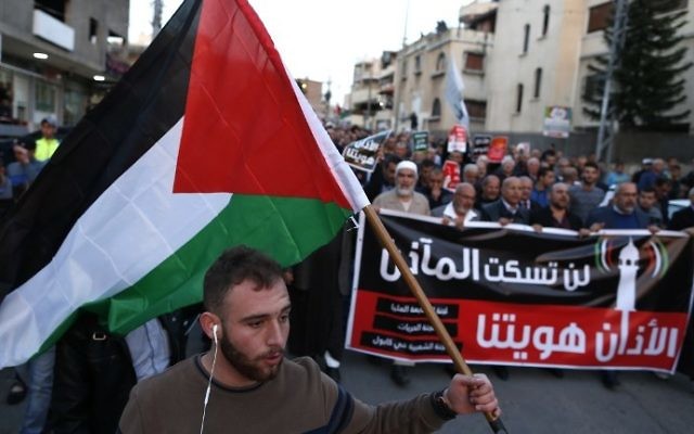 Arab Israelis march in the northern Arab town of Kabul, 14 kilometers southeast of Acre, during a demonstration against a planned Israeli legislation that would quieten mosques, on March 11, 2017. The writing in Arabic reads: ''Our mosques won't be silenced." (AFP PHOTO / AHMAD GHARABLI) Arab Israelis march in the northern Arab town of Kabul, 14 kilometers southeast of Acre, during a demonstration against a planned Israeli legislation that would quieten mosques, on March 11, 2017. The writing in Arabic reads: ''Our mosques won't be silenced." (AFP PHOTO / AHMAD GHARABLI)