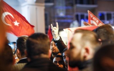 A demonstrator makes the nationalist 'grey wolves' sign during a gathering outside the Turkish consulate in Rotterdam, on March 11, 2017 after Netherlands refused Turkish Foreign Minister Mevlut Cavusoglu permission to land for a rally to gather support for a referendum on boosting Turkish president Erdogan's powers. (AFP PHOTO / ANP / Bas Czerwinski)