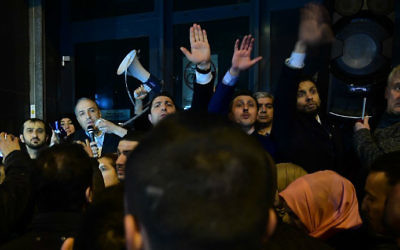 The Turkish ambassador to the Netherlands, second from left, addresses Turkish residents of the Netherlands gathered for a protest outside Turkey's consulate in Rotterdam on March 11, 2017. (Emmanuel Dunand/AFP)