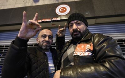 Supports of Turkish President Recep Tayyip Erdogan (not pictured) gesture in front of the Turkish Consulate in Rotterdam on March 12, 2017. (John Thys/AFP)