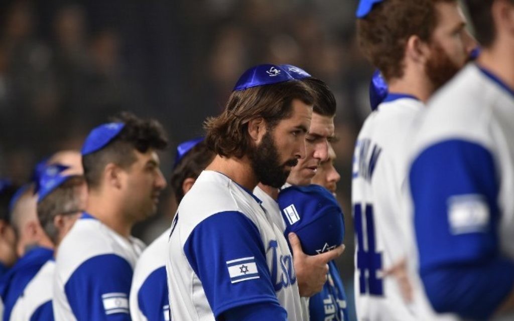 Israel's pitcher Joey Wagman (C) and his teammates sing the national anthem prior to the team's second round match against The Netherlands in Tokyo on March 13, 2017. (AFP Photo/Kazuhiro Nogi)