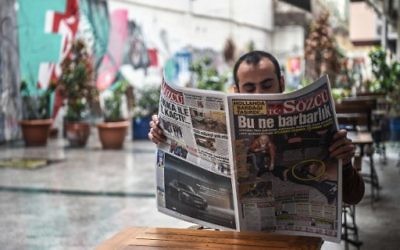 A man reads a newspaper bearing a headline concerning diplomatic tensions between Turkey and The Netherlands, which translates as "What a Barbarism" in Istanbul on March 13, 2017. (Ozan Kose/AFP)