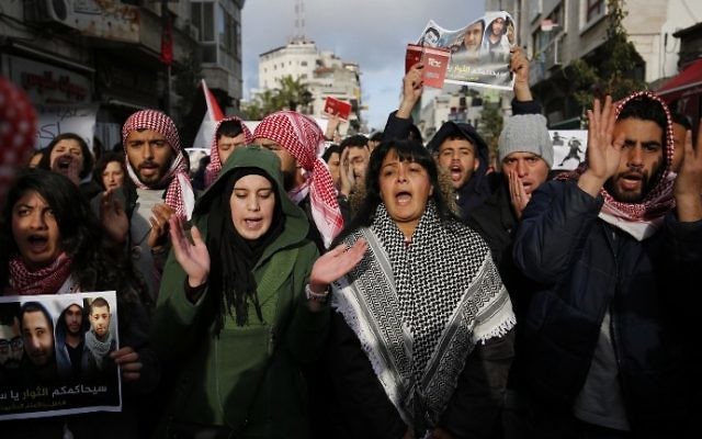 Palestinian demonstrators march in the West Bank city of Ramallah against the security coordination between PA security forces and Israel on March 13, 2017. (AFP Photo/Abbas Momani) Palestinian demonstrators march in the West Bank city of Ramallah against the security coordination between PA security forces and Israel on March 13, 2017. (AFP Photo/Abbas Momani)