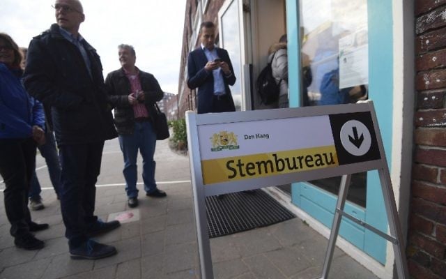 Voters queue outside a polling station at The Hague on March 15, 2017, as polls open across the Netherlands. (Emmanuel Dunand/AFP) Voters queue outside a polling station at The Hague on March 15, 2017, as polls open across the Netherlands. (Emmanuel Dunand/AFP)