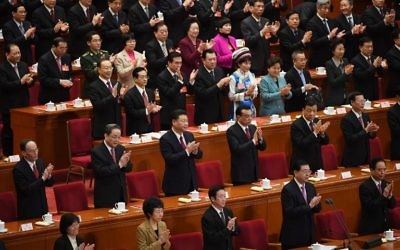 Chinese leaders, including (2nd row L-R) Wang Qishan, Yu Zhengsheng, President Xi Jinping, Premier Li Keqiang, Liu Yunshan and Zhang Gaoli, applaud during the closing ceremony of the National People's Congress (NPC), China's rubber-stamp legislature, in the Great Hall of the People in Beijing on March 15, 2017. (Greg Baker/AFP)