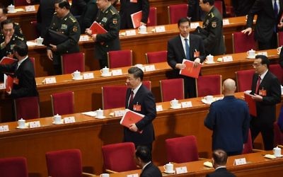 Chinese President Xi Jinping (C) walks out after the closing session of the National People's Congress, China's legislature, at the Great Hall of the People in Beijing on March 15, 2017.(Greg Baker/AFP)