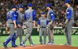 Israeli infielders and a coach gather around picher Josh Zeid (#28) in the bottom of the third inning during the World Baseball Classic Pool E second round match between Israel and Japan at Tokyo Dome in Tokyo on March 15, 2017. (AFP PHOTO / TORU YAMANAKA)