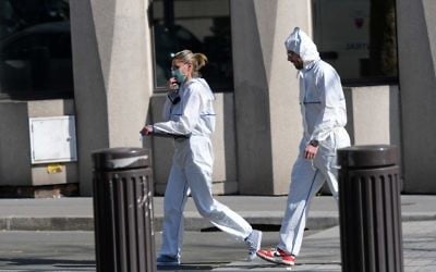 Members of the Police Forensic team leave the Paris offices of the International Monetary Fund (IMF) on March 16, 2017 in Paris, after a letter bomb exploded in the premises. (Christophe Archambault/AFP) 