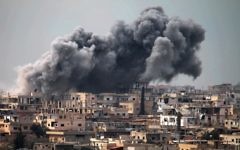 Illustrative: Smoke billows following reported air strikes on a rebel-held area in the southern city of Daraa, on March 16, 2017. (AFP Photo/Mohamad Abazeed)
