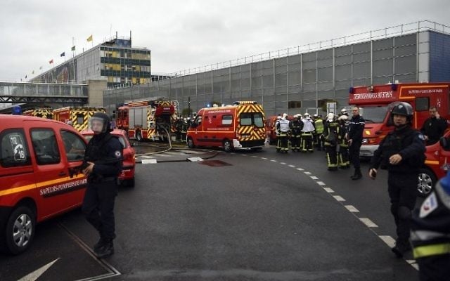 French policemen and firefighters secure the area at Paris' Orly airport on March 18, 2017 following the shooting of a man by French security forces. (AFP PHOTO / CHRISTOPHE SIMON)