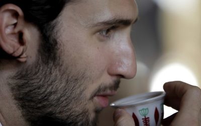 Taymur Jumblatt, son of Lebanese Druze political leader Walid Jumblatt, drinking coffee during a farewell lunch for an Israeli-Arab Druze delegation at Jumblatt's residence in Mukhtara, southeast of Beirut, July 24, 2010 (AFP PHOTO / Joseph EID)