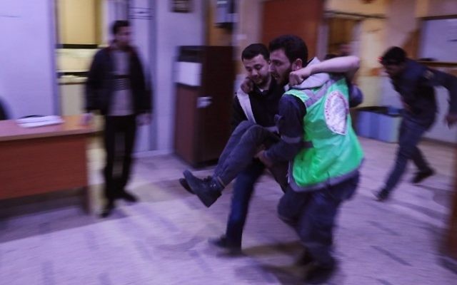 Syrian medics arrive with a victim at a make-shift hospital following reported air strikes on the rebel-held town of Douma, on the eastern outskirts of the capital Damascus, on March 19, 2017. (AFP PHOTO / Abd Doumany) Syrian medics arrive with a victim at a make-shift hospital following reported air strikes on the rebel-held town of Douma, on the eastern outskirts of the capital Damascus, on March 19, 2017. (AFP PHOTO / Abd Doumany)
